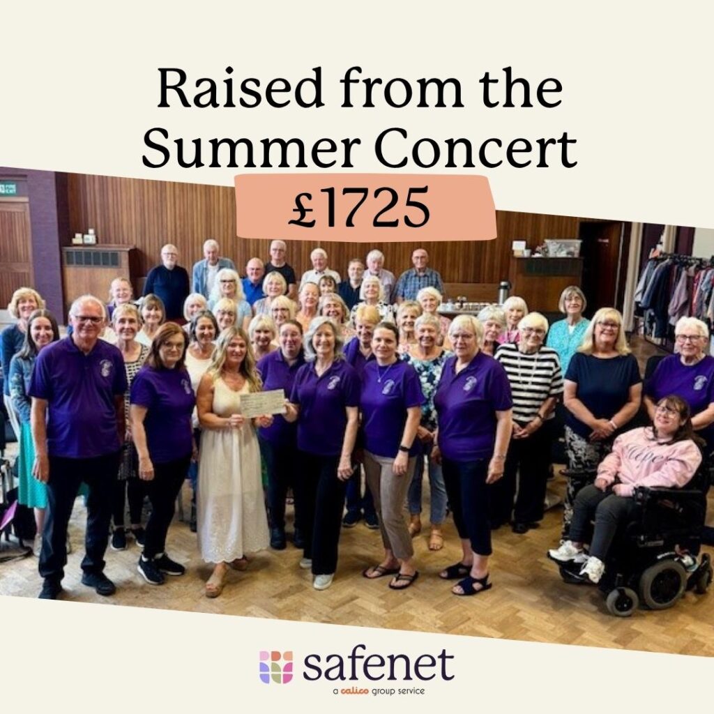 A group of people, the majority dressed in blue, in a small concert hall. Text above the image reads "Raised from the Summer Concert £1725" The Safenet logo is displayed at the bottom of the image.